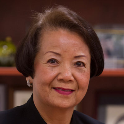 Portrait of Kim Nguyen smiling at the camera.